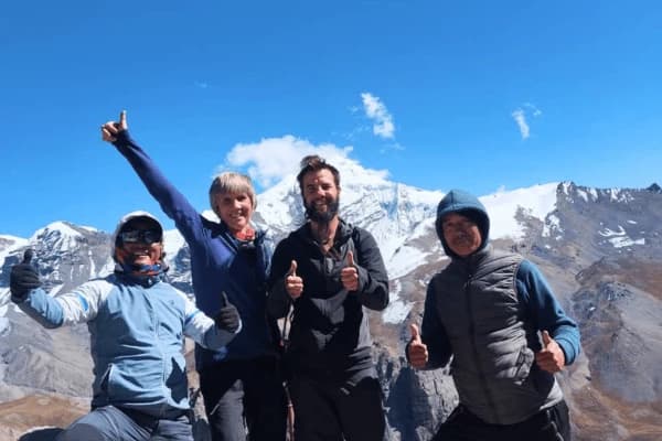 Happy-trekkers-posing-with-snow-capped-mountains-during-the-Upper-Mustang-Trek-in-Nepal