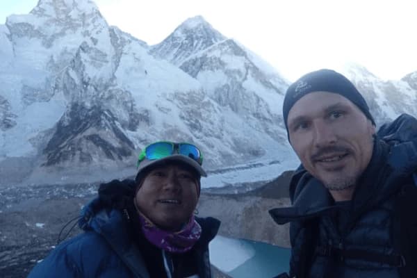 trekking-guide-and-climber-posing-before-a-massive-himalayan-glacier